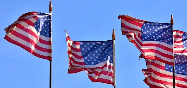 USA flag waving in the blue sky.