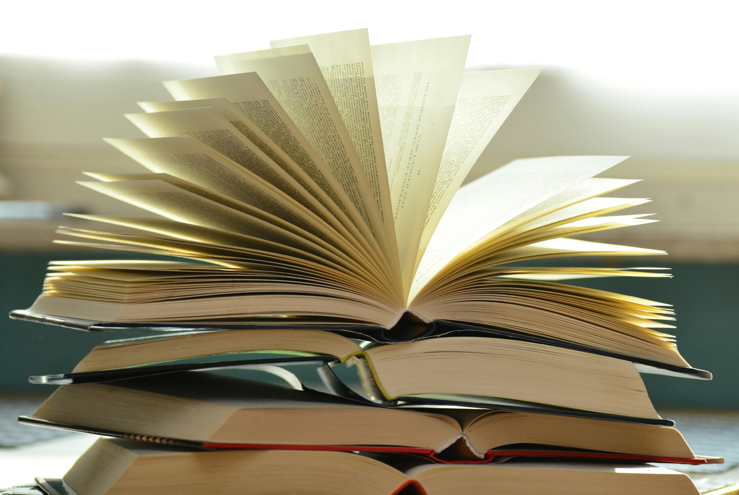 books-book-pages-read-literature-159866-159866-1 A close-up of a stack of open books with pages fanned out, capturing a study atmosphere.